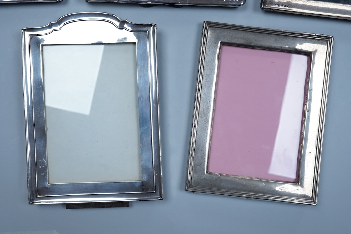 Three assorted George V silver mounted photograph frames, largest 23.9cm by 18.2cm, together with a pair of modern Art Nouveau style silver mounted photograph frames, PP & A, London, 1981.